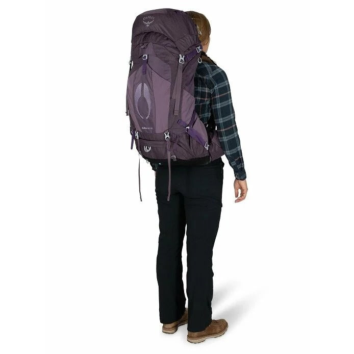 Person wearing a large purple backpack on a white background