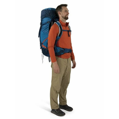 Man wearing a large blue backpack on a white background