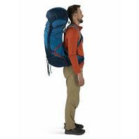 Man wearing a large blue backpack on a white background