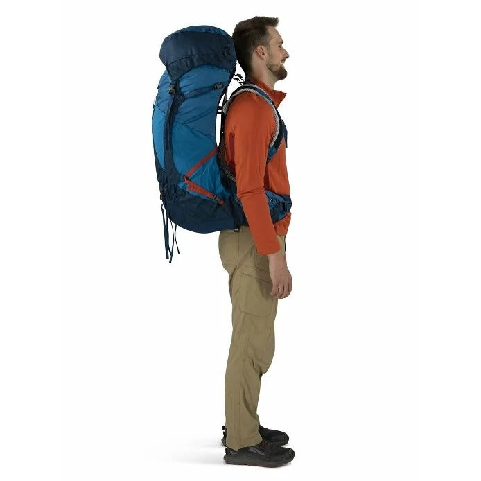 Man wearing a large blue backpack on a white background