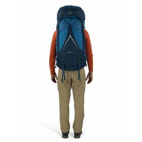 Person wearing a blue Osprey backpack on a white background