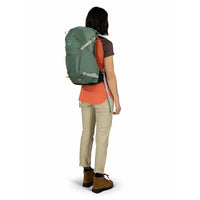 Person wearing a green and orange backpack on a white background