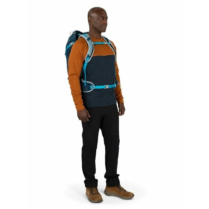 Man wearing a blue and orange backpack on a white background