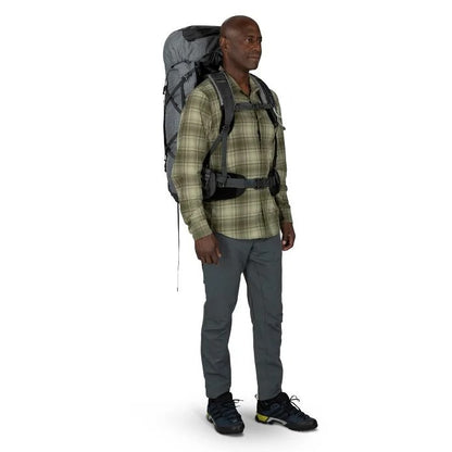 Man wearing a hiking backpack on a white background