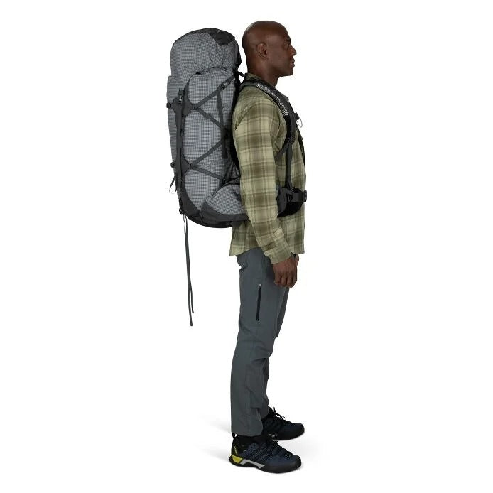 Man wearing a large gray backpack on a white background