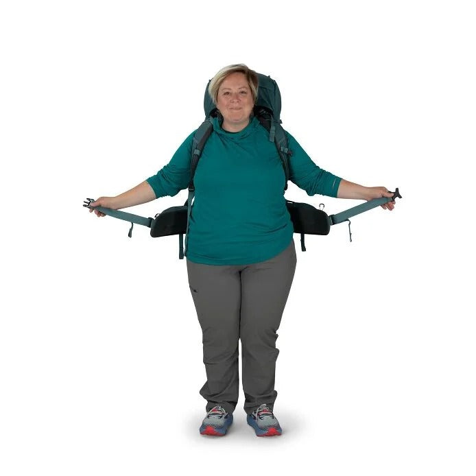Person wearing a large backpack on a white background