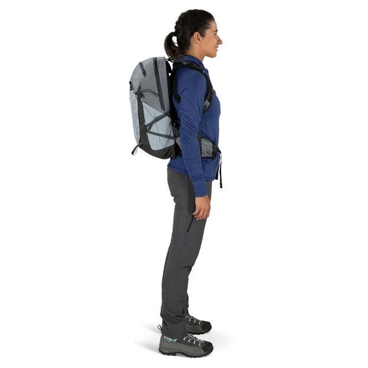 Person wearing a gray and black backpack on a white background