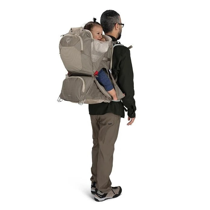 Man carrying a child in a baby carrier on a white background