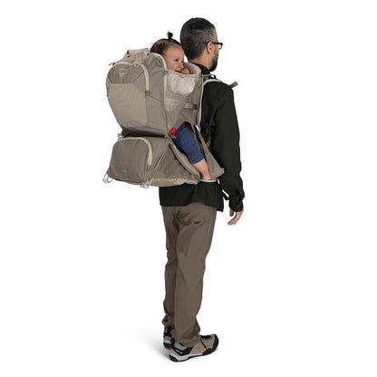 Man carrying a child in a baby carrier on a white background