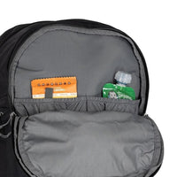 Gray backpack with a small compartment containing a caramel candy bar and a green bottle.