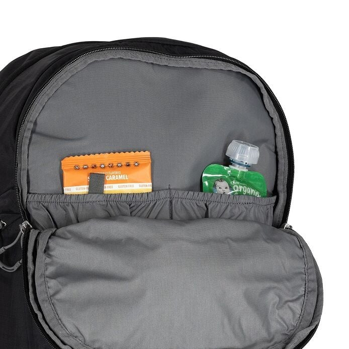 Gray backpack with a small compartment containing a caramel candy bar and a green bottle.