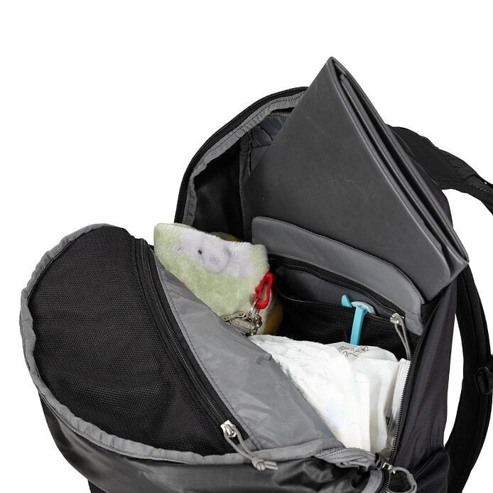 Black backpack with items inside on a white background