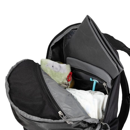 Black backpack with items inside on a white background