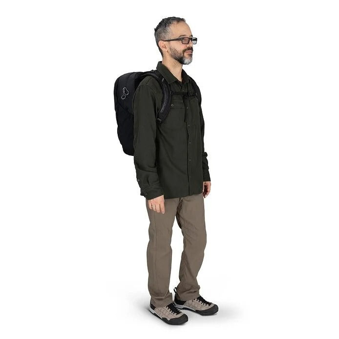 Man wearing a black backpack on a white background