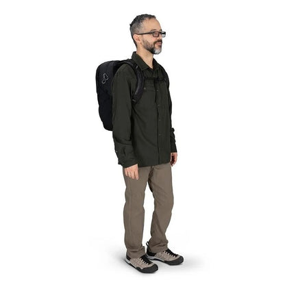 Man wearing a black backpack on a white background