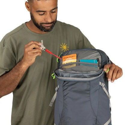 Man opening a gray backpack with a white background