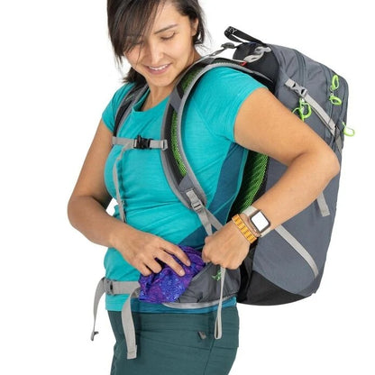 Woman wearing a gray backpack with a white background