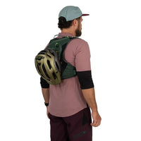 Man wearing a green backpack with a helmet on a white background