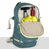 Green backpack with open compartment showing items on a white background