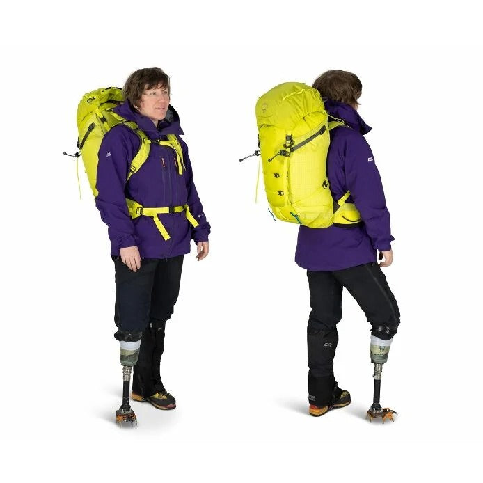 Person wearing a purple jacket and black pants with a yellow backpack, shown from front and back on a white background.