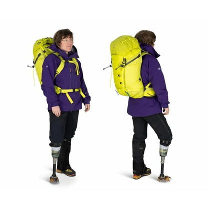 Person wearing a purple jacket and black pants with a yellow backpack, shown from front and back on a white background.