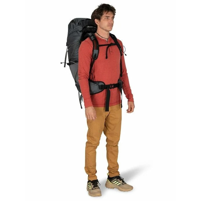 Man wearing a large backpack on a white background