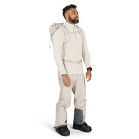 Man wearing a full-body beige snowsuit with a hood on a white background