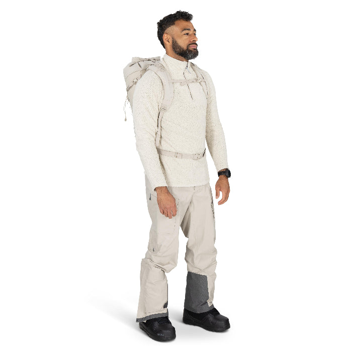 Man wearing a beige snowsuit with a hood on a white background