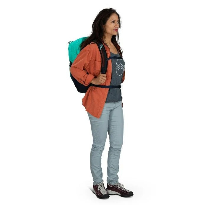 30L backpack worn by a person in orange jacket with teal backpack