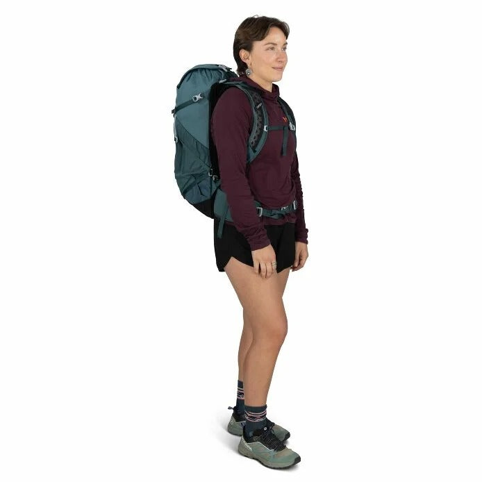 Teal hiking backpack worn on back with padded shoulder straps and adjustable harness