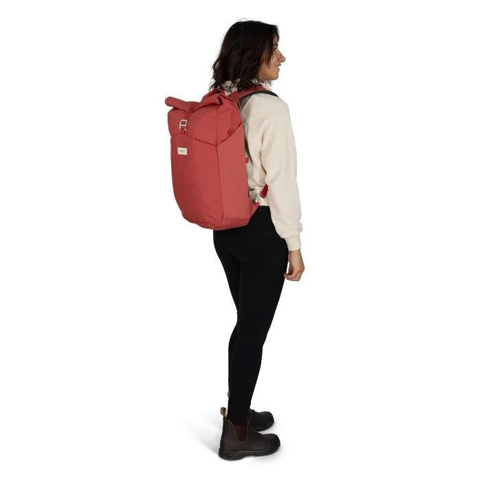 Person wearing a red backpack on a white background
