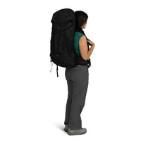 Person wearing a large black backpack on a white background