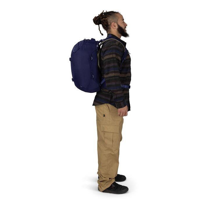 Blue travel backpack on back, side profile with front strap details