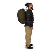 Olive green travel pack on back, side profile with shoulder straps and hip belt