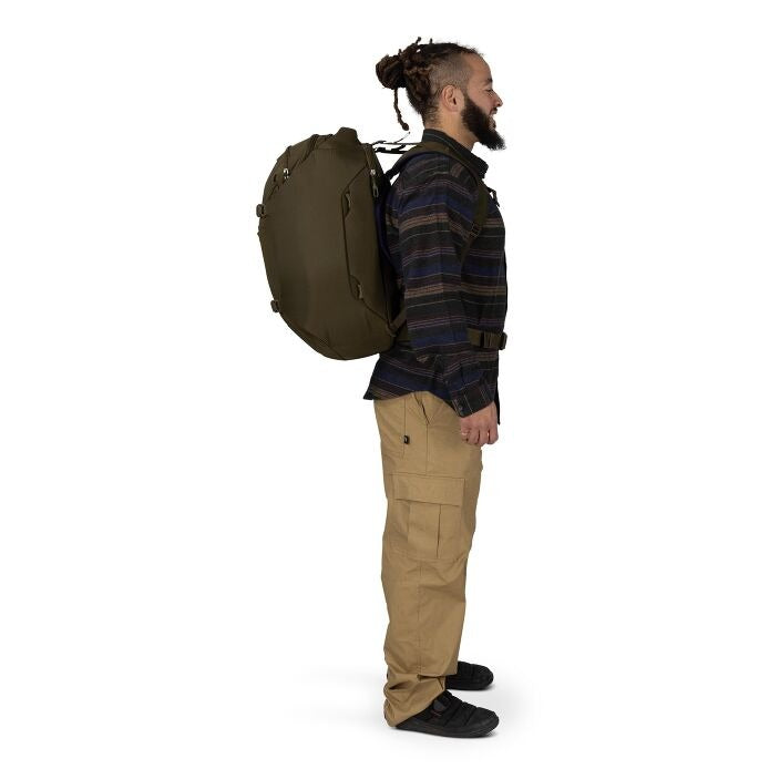 Olive green travel pack on back, side profile with shoulder straps and hip belt