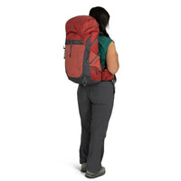 Person wearing a red backpack on a white background
