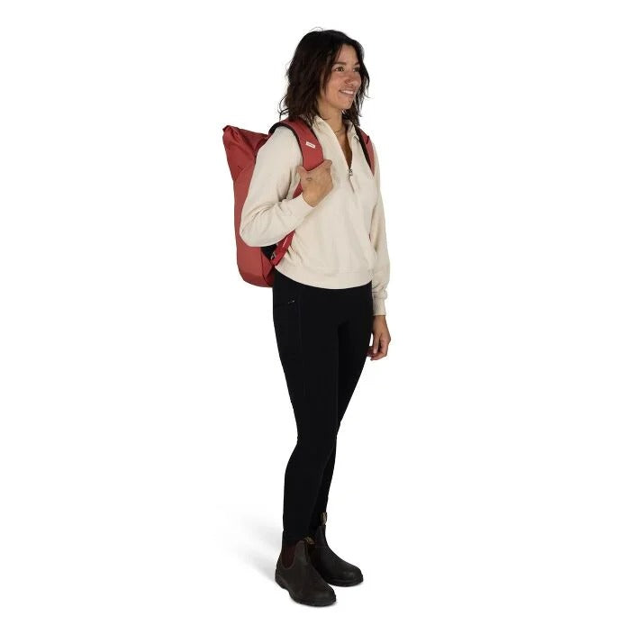 Woman carrying a red backpack on a white background