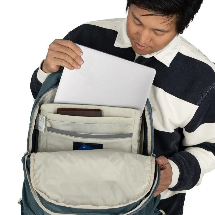 Open daypack backpack showing light interior compartments and padded laptop sleeve