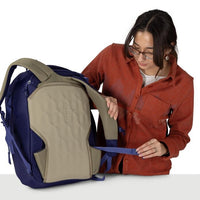 Blue travel backpack opened to beige inner compartment with front zipper access