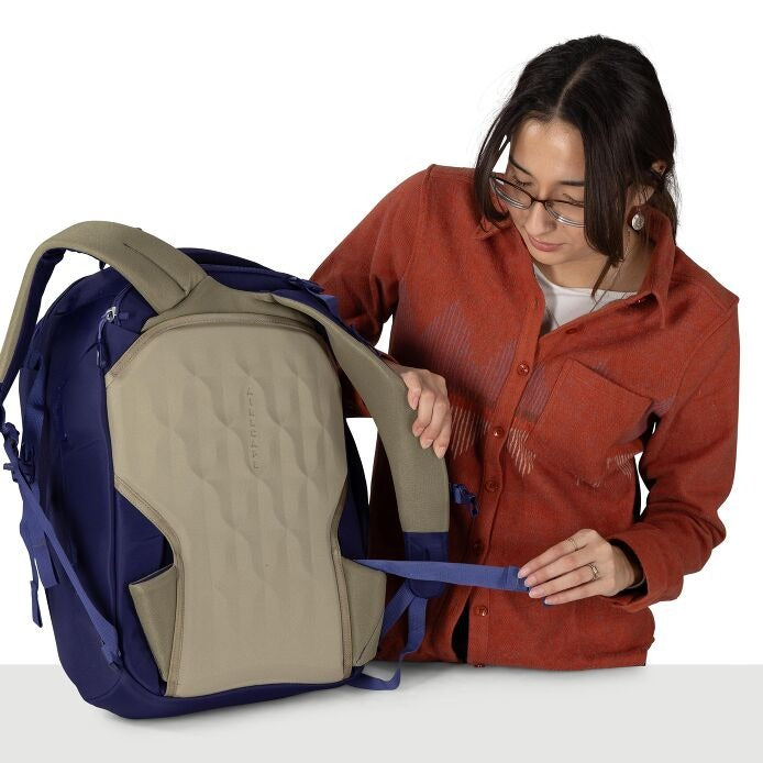 Blue travel backpack opened to beige inner compartment with front zipper access