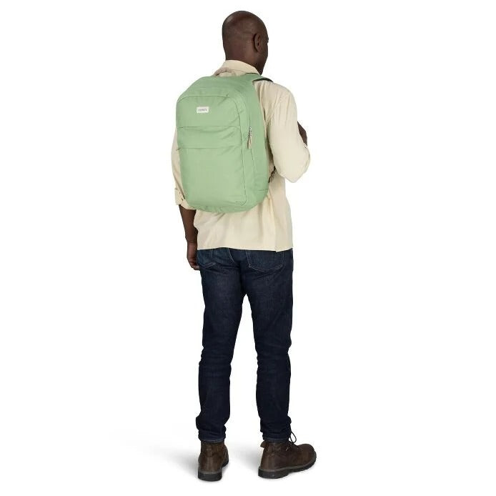 Person wearing a green backpack on a white background