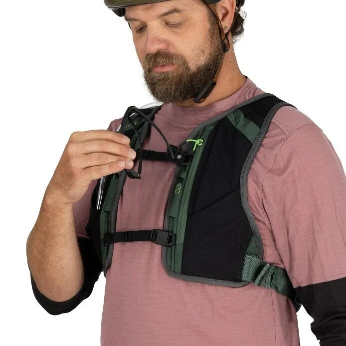Man wearing a green and black backpack on a white background