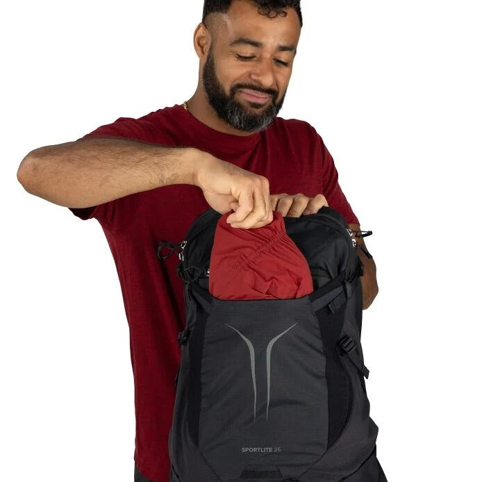 Black hiking backpack with curved front panel, zip pocket, and cinch straps