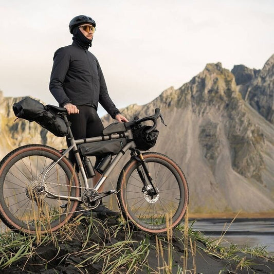 Person with a bicycle in a mountainous landscape