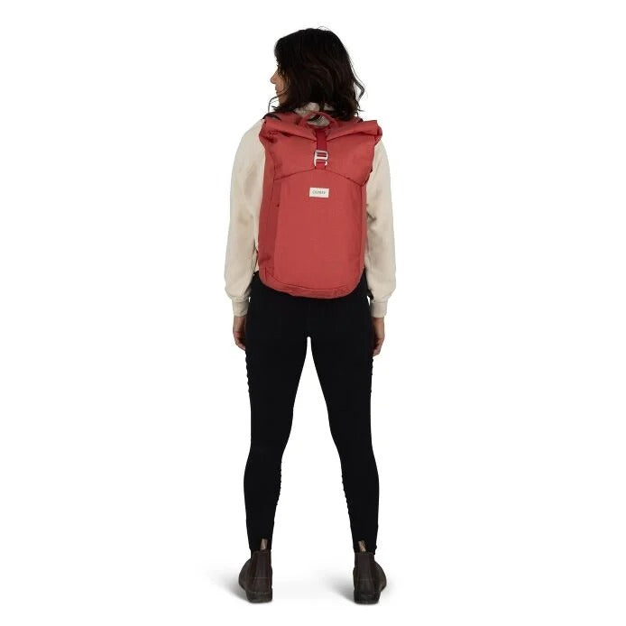 Person wearing a red backpack on a white background