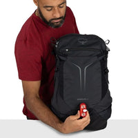Black hiking backpack with top front pocket and front hydration-style access panel