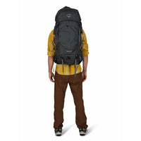 Person wearing a large black backpack on a white background