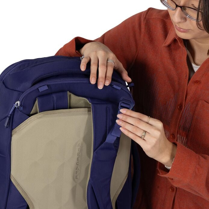 Close-up of blue travel backpack front zipper and beige inner panel