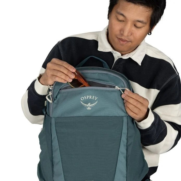 Teal daypack backpack close-up of front panel with OSPREY emblem and zipper