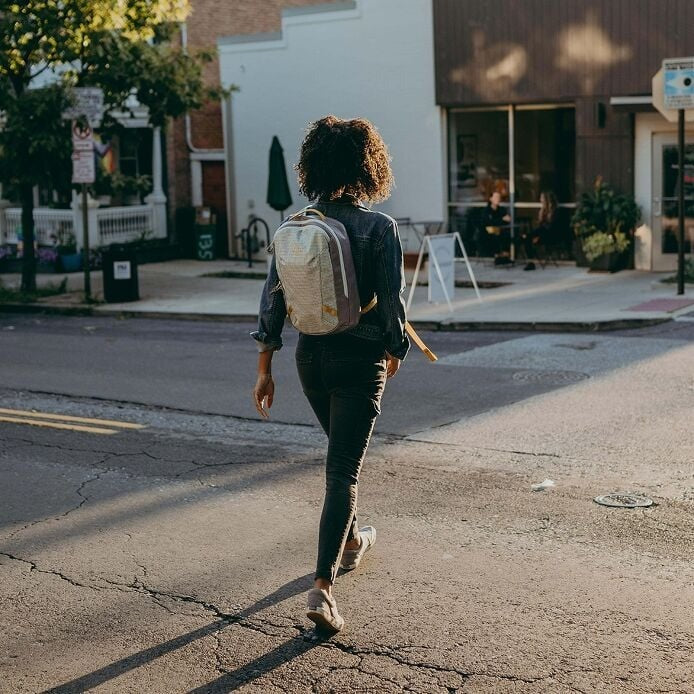 Person walking on a street with a backpack